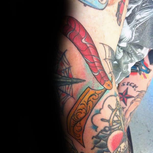 Impressive Yellow Red Straight Razor Tattoo For Males On Forearm
