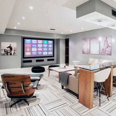 basement movie room large screen glass bar eames chair 