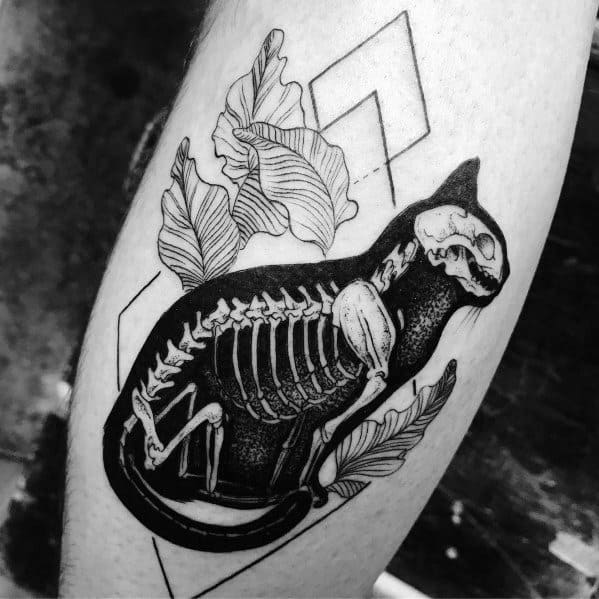 Blackwork cat tattoo featuring an X-ray-style skeleton, floral elements, and geometric shapes for a bold and artistic design.