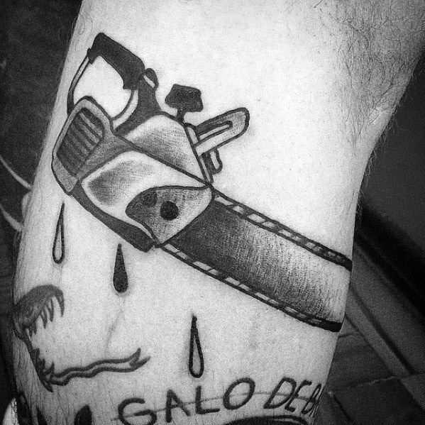 Black and gray chainsaw tattoo with thick shading and dripping blood details, paired with a snarling mouth outline below.
