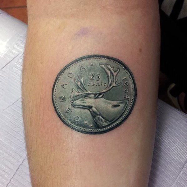 Realistic tattoo of a 1967 Canadian 25-cent coin featuring a caribou, with intricate shading for a three-dimensional effect on the arm.