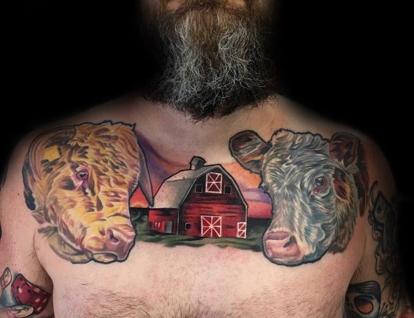 Colorful chest tattoo featuring two realistic cow heads and a red barn at sunset, symbolizing farm life and rural pride.