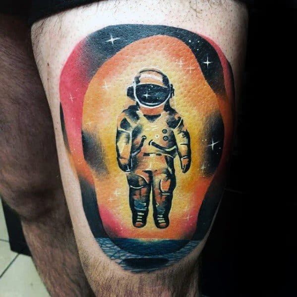 Deja Entendu astronaut tattoo with a cosmic twist, featuring a glowing orange aura, starry black sky, and textured ocean below.