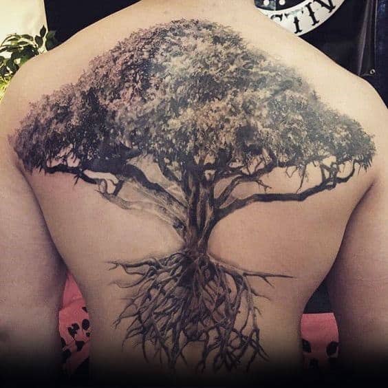 Intricate tree tattoo with roots covering a person's entire back