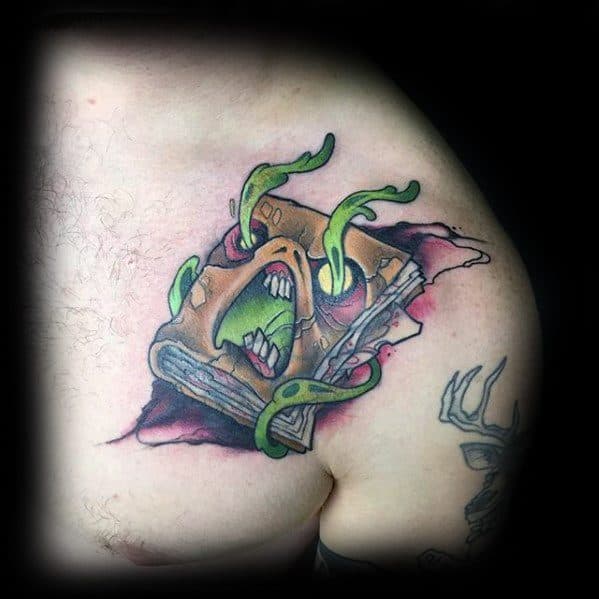 Cartoon-style Evil Dead tattoo of a screaming Necronomicon with sharp teeth and green tentacles bursting out, set on a torn flesh backdrop