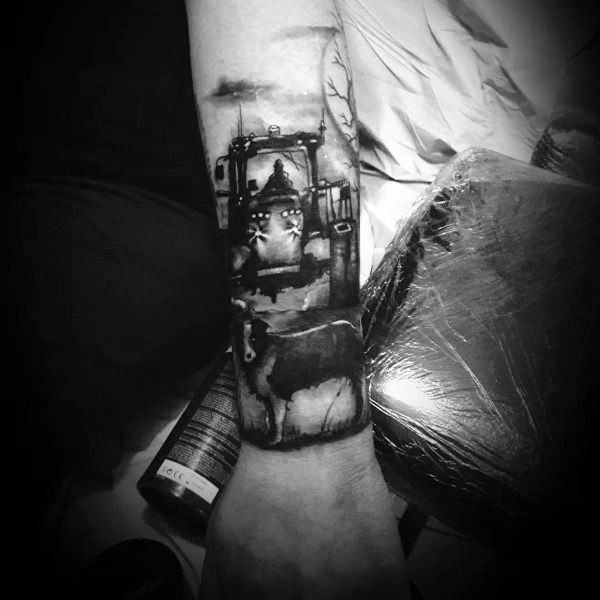 Realistic black and gray tattoo of a tractor with headlights on and a cow in the foreground, set in a dark rural scene.