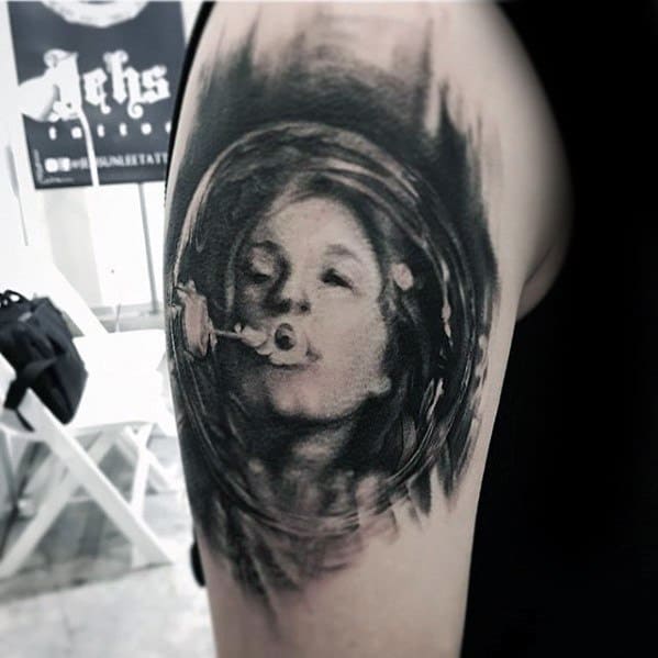 Black and grey tattoo of a young girl blowing bubbles, with a surreal, dreamy background that blends into abstract swirls, capturing a sense of movement and whimsy.