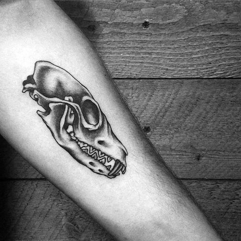 Small black and grey tattoo of a fox skull on the inner forearm, with smooth shading and clean linework.