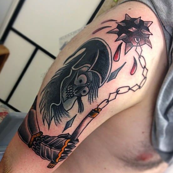 Bold tattoo of a spiked flail with dripping blood, wielded by a skeletal figure in a helmet, emerging from an armored gauntlet.