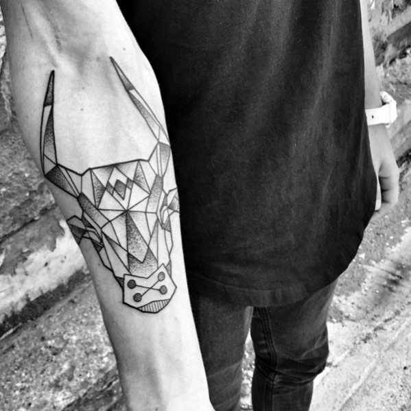 Geometric bull head tattoo on the forearm with sharp angular lines, abstract shapes, and a bold modern design.