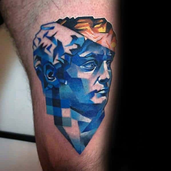 Vibrant glitch tattoo of Michelangelo’s David in angular blue tones with pixelated blocks and orange highlights on the hair