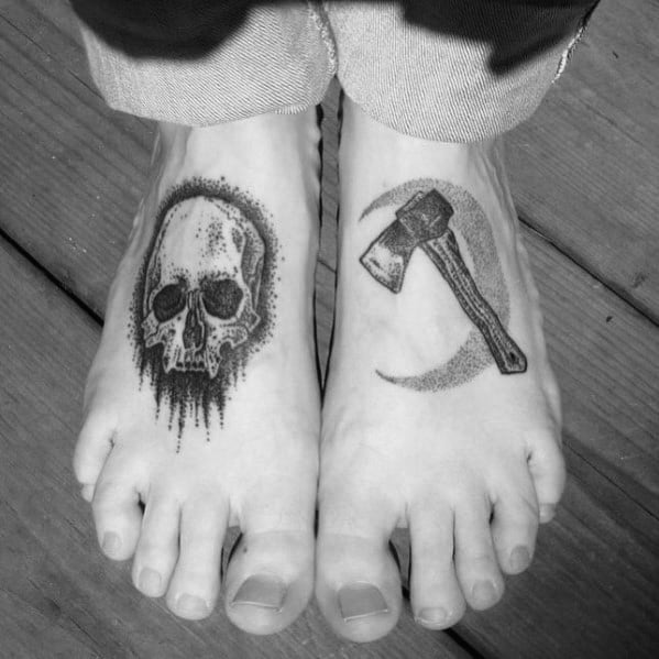 Black and grey foot tattoos featuring a dripping skull on one foot and a hatchet with a crescent moon on the other, designed with fine dotwork shading.