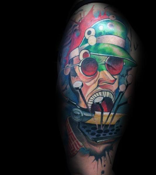 Vibrant Hunter S. Thompson-inspired tattoo featuring a surreal, psychedelic portrait with red-tinted aviator glasses, a green hat, and a chaotic expression.