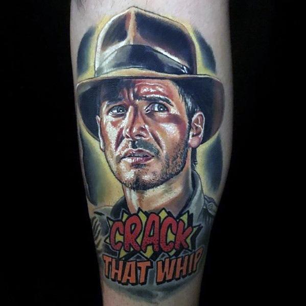 Colorful Indiana Jones tattoo featuring his intense expression, iconic fedora, and the phrase 'Crack That Whip' in bold comic-style text.