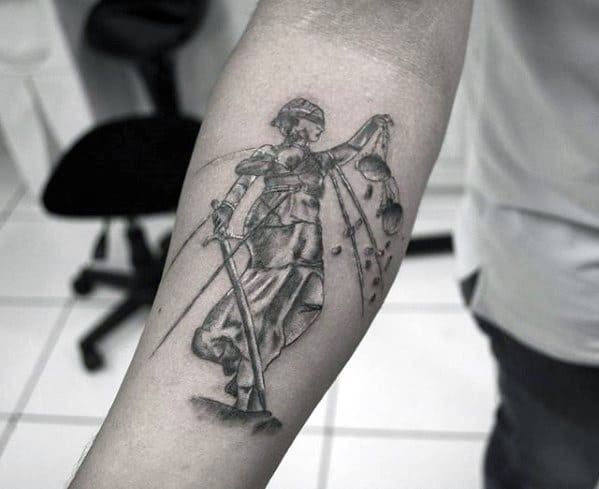 Black and grey tattoo of Lady Justice with broken scales and sword, inspired by Metallica’s ...And Justice for All imagery.