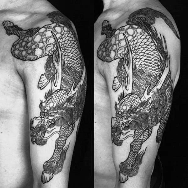 Detailed black ink Kirin tattoo on upper arm with intricate scales, sharp horns, and a dynamic pose emphasizing traditional Eastern style.