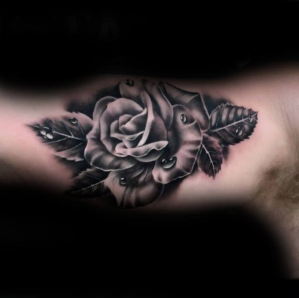 Black and gray rose tattoo with leaves and water droplets