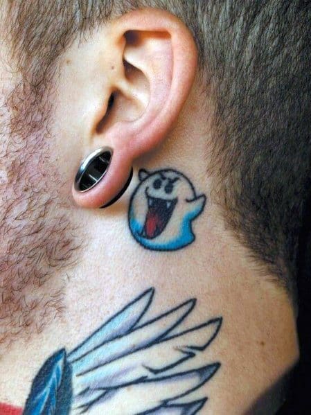 Small Mario ghost tattoo featuring Boo with a cheerful expression, blue shading, and bold outlines, inked behind the ear for a subtle look.