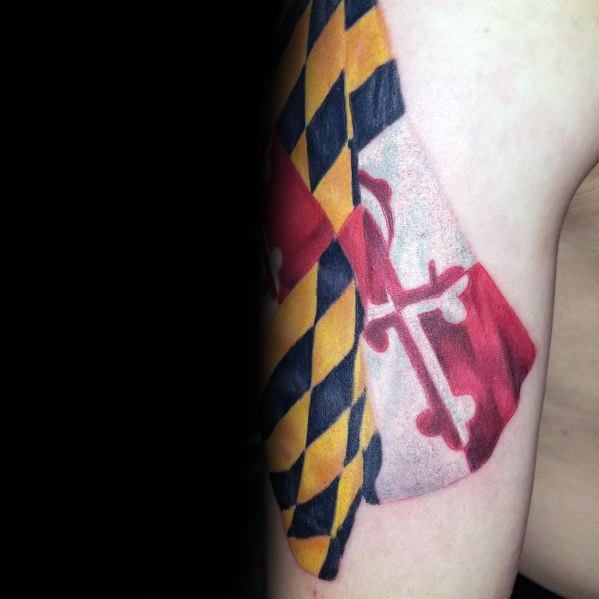 Maryland flag tattoo on the upper arm with a realistic draped fabric effect, showcasing bold colors and intricate shading for a lifelike appearance.