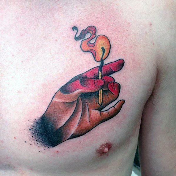 Colorful chest tattoo of a stylized hand holding a lit match with swirling smoke, symbolizing creation, control, and the spark of life.