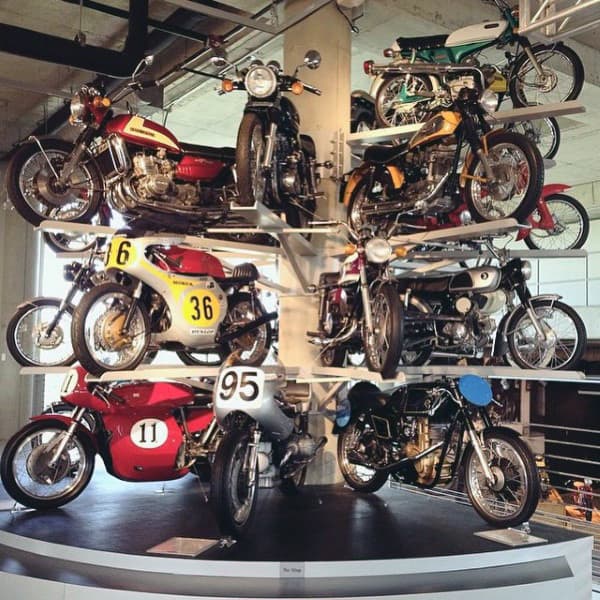 Rotating display of vintage motorcycles in a stylish dream garage.