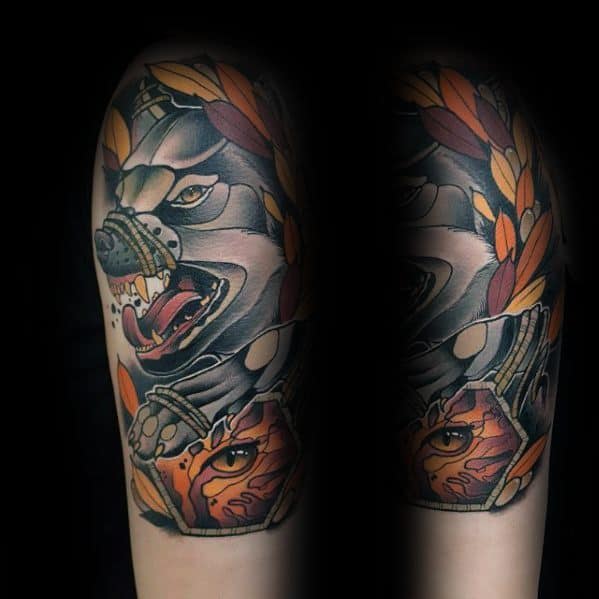 Neo-traditional tattoo of a snarling wolf with laurel leaves, bold shading, and intricate details, featuring a striking eye design.