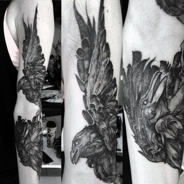 Highly detailed black and grey forearm tattoo of a raven in flight, shown from multiple angles with rich feather texture and motion.