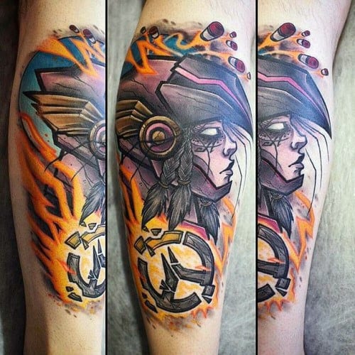 Vivid tattoo of Pharah from Overwatch in a bold, artistic style with tribal elements and the Overwatch logo on a man's calf.