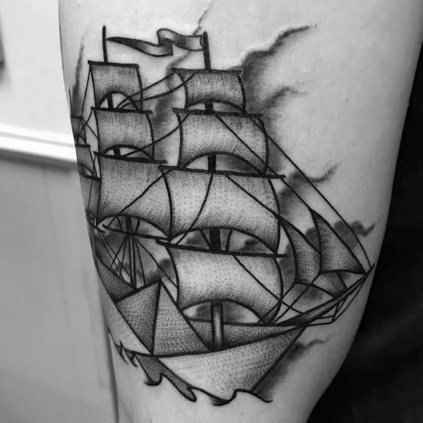 Creative tattoo blending a paper boat with a detailed sailing ship, symbolizing transformation, ambition, and the journey ahead.