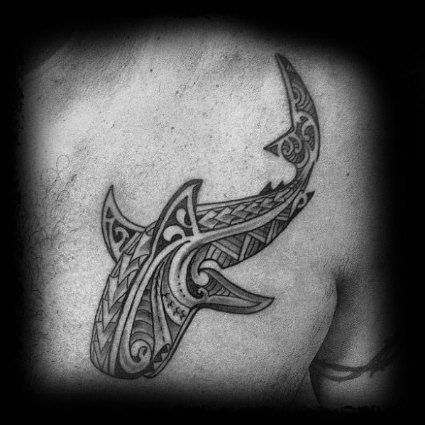 Polynesian hammerhead shark tattoo on chest with intricate tribal motifs representing guidance, strength, and spiritual protection.
