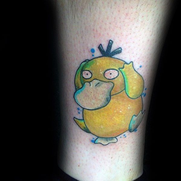 Colorful Psyduck tattoo with wide eyes and a distressed pose, accented by blue splashes, inked on a man's lower leg.