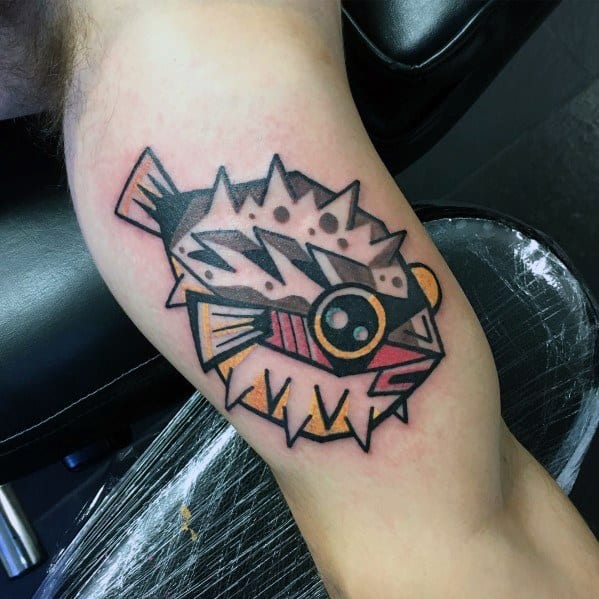 Bold neo-traditional pufferfish tattoo with sharp geometric shapes, thick outlines, and vibrant colors for a striking and modern design.