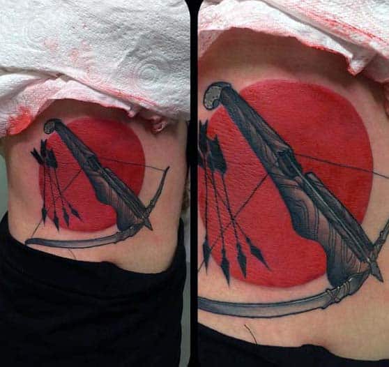 Incredible Red Bow And Arrow Mens Archery Tattoo Design On Lower Rib Cage Side