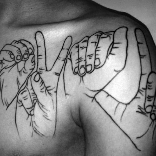 bold black line tattoo of hands signing a word in American Sign Language, spanning across the chest and shoulder with intricate detailing
