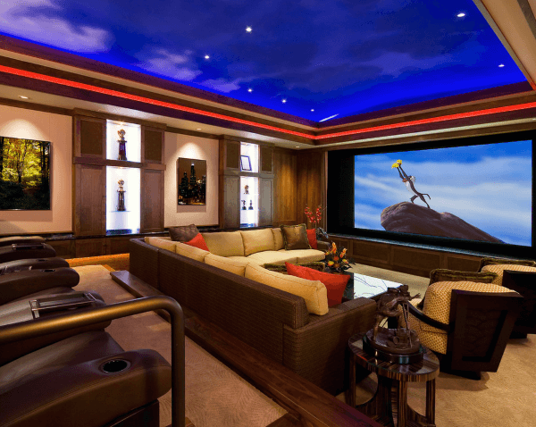 Luxurious home theater boasts a large screen for animated films, surrounded by cozy seating and ambient lighting