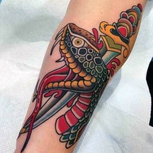 Colorful snake and dagger tattoo on forearm, featuring intricate scales, bold red and yellow accents, and dynamic traditional design elements.