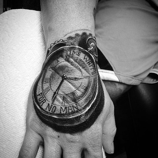 Realistic black and grey pocket watch tattoo on the hand with Roman numerals and the phrase Time Waits for No Man.
