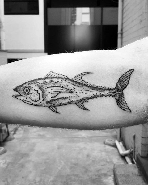Black and grey tuna fish tattoo on a man's forearm, featuring fine line details and shading for a realistic and minimalistic design.