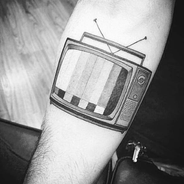 Black and grey tattoo of a vintage TV displaying a test pattern, with classic dials and antennas, inked in a clean and bold style.