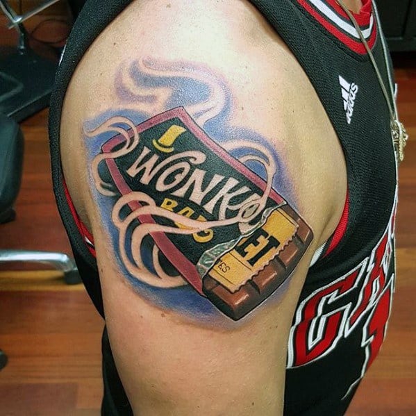 Bold Wonka Bar tattoo on the upper arm with swirling purple and pink accents, showing an unwrapped chocolate bar and golden ticket.