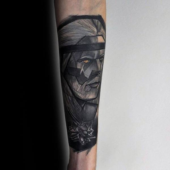 Stylized geometric Witcher tattoo on the forearm featuring Geralt’s angular portrait with a glowing eye and detailed wolf medallion.