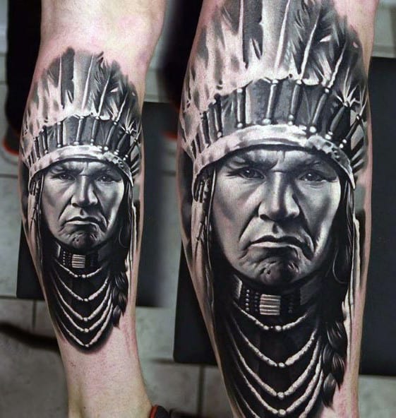 Tattoo of a stern-faced Native American chief wearing a headdress on a person's leg