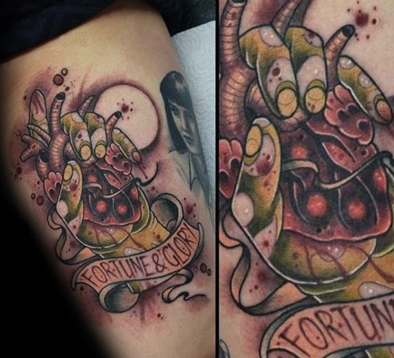 Indiana Jones-inspired tattoo featuring a beating heart in a dramatic, stylized design with 'Fortune & Glory' banner, referencing Temple of Doom.