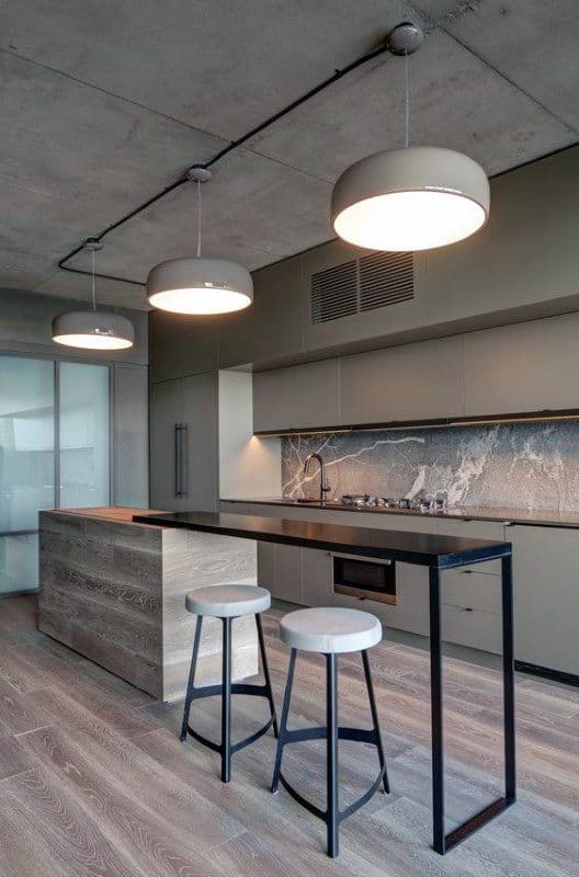 Minimalist industrial kitchen with concrete ceiling, modern lighting, and sleek bar seating.