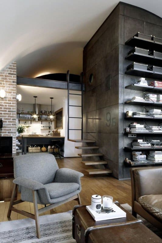 Industrial living space with exposed brick, metal shelving, and a loft area.