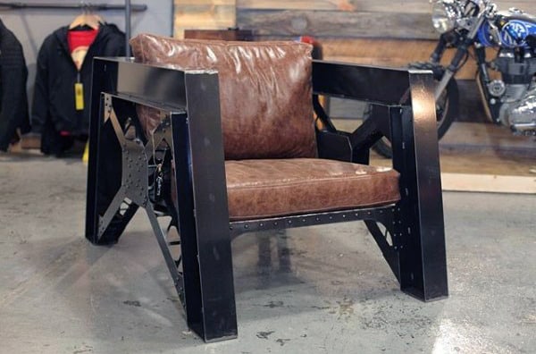 Industrial-style chair with leather cushions and metal frame in a workshop setting