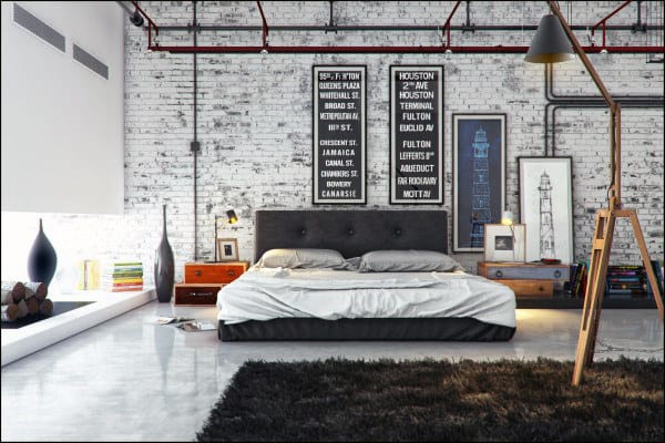 Industrial warehouse bedroom with platform bed, exposed brick wall, and large brown rug.