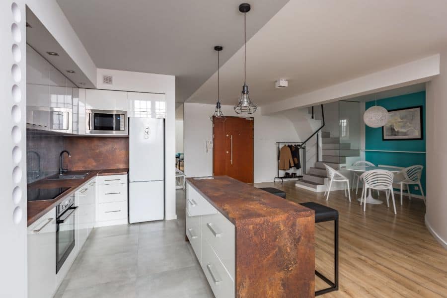industrial style kitchen with white cabinets