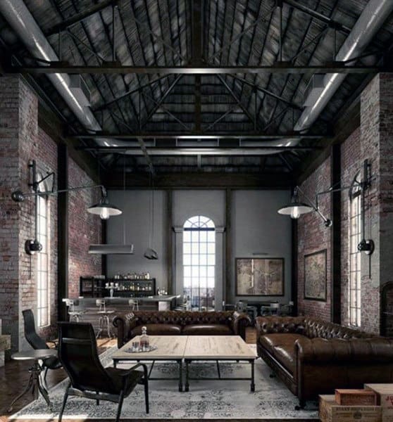 Industrial-style loft with exposed brick walls, leather sofas, high ceiling, large window, and minimalist decor