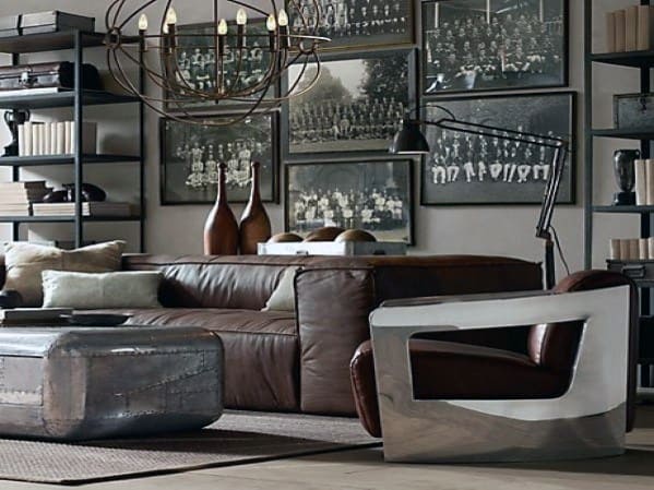 Brown leather sectional sofa in an industrial living room with metal accents and vintage decor.